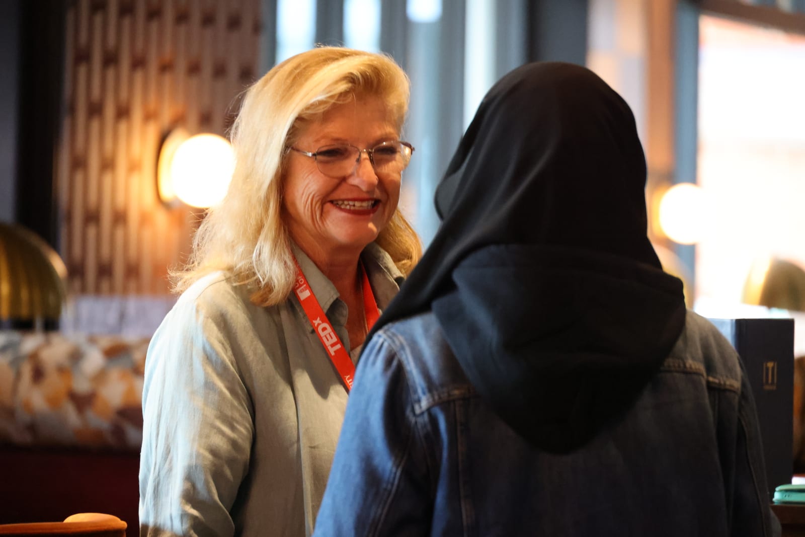 Two attendees sharing a conversation during a networking break
