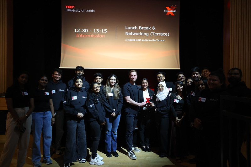 The event team gathered in front of the Lunch Break & Networking slide
